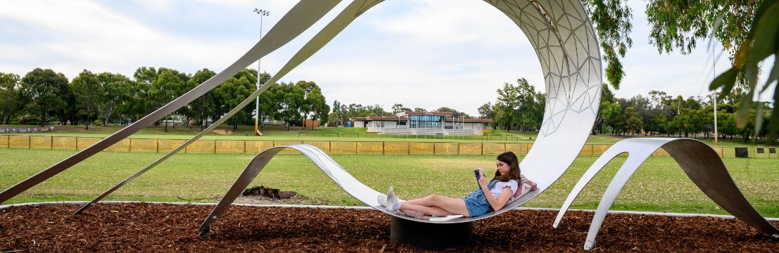 Image of a child enjoying the sculpture at Hamer Park